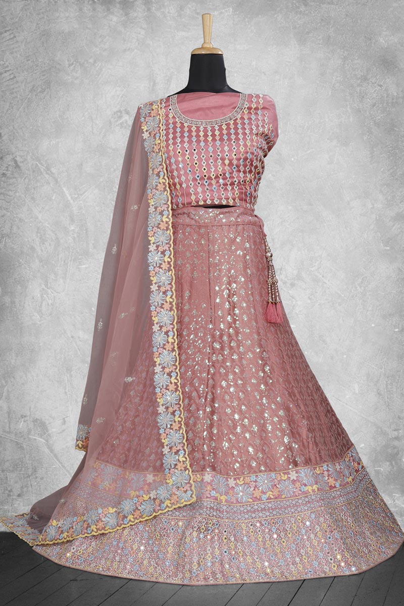 Dazzling Embroidered Work On Peach Color Lehenga In Net Fabric