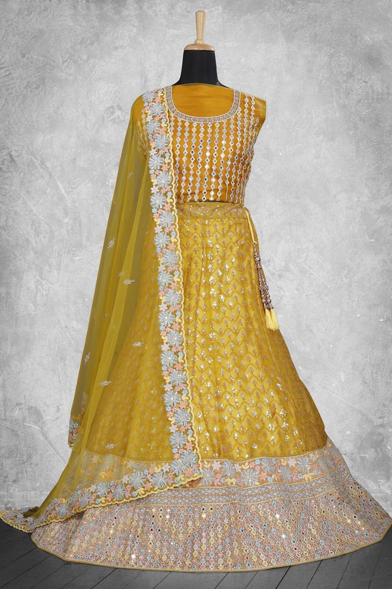 Entrancing Net Fabric Lehenga In Mustard Color With Embroidered Work
